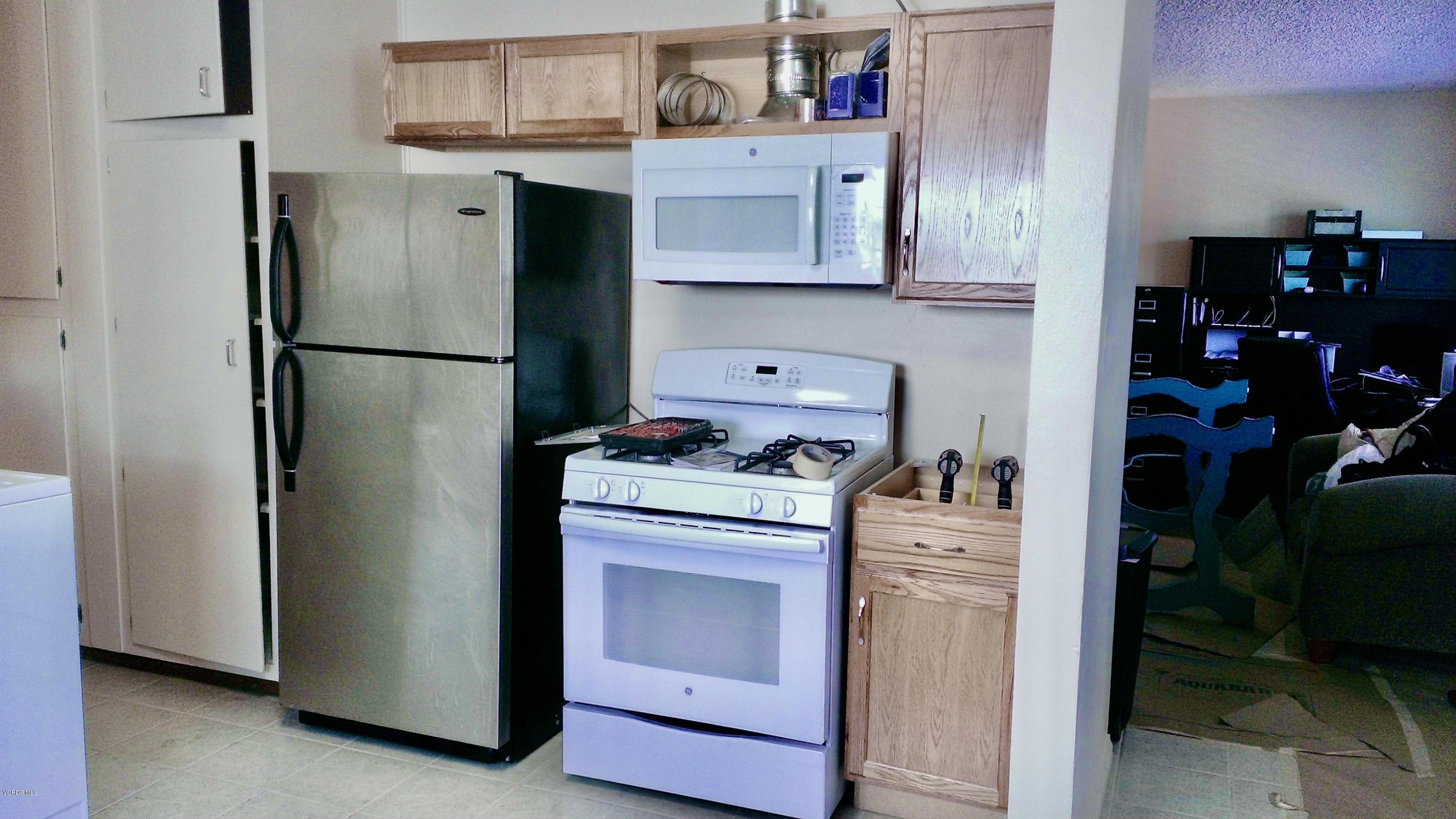 246 Valley Road Oak View, CA 93022 - Photo 10 of 34 a kitchen with stainless steel appliances granite countertop a refrigerator a stove and a sink
