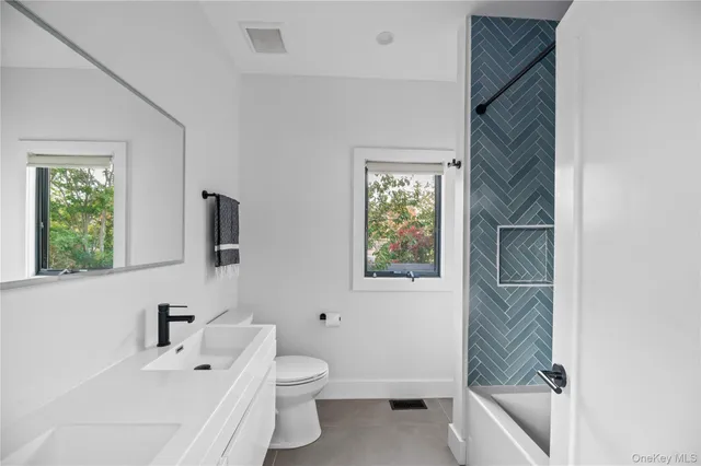 a bathroom with a sink a toilet and a bathtub