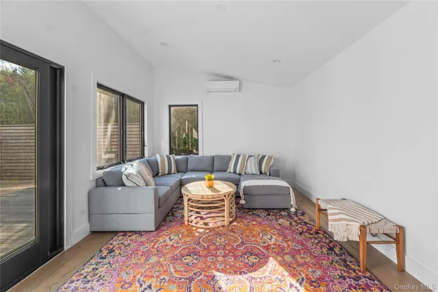 a bedroom with furniture and a large window
