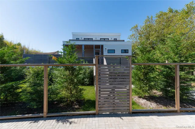 a view of a house with a yard and potted plants
