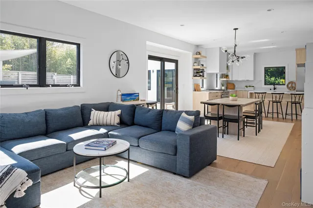 a living room with furniture a table and a large window