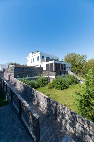 a view of a large building with a big yard and potted plants