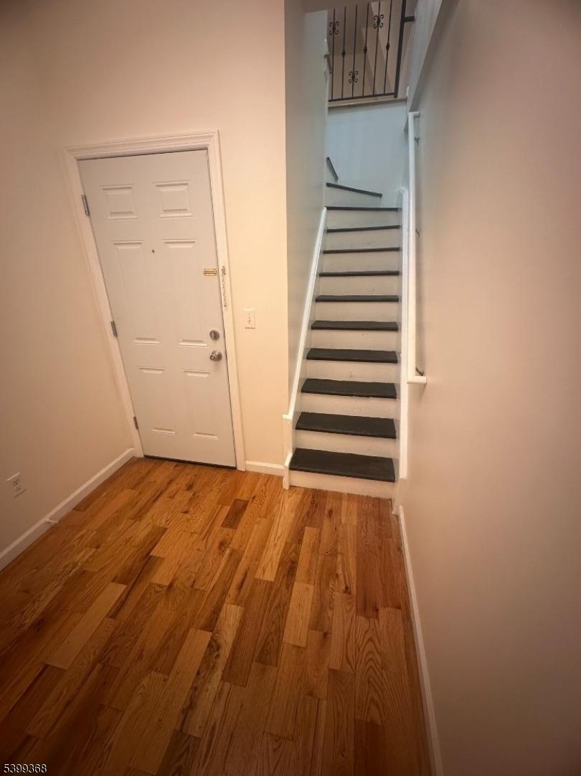 192 Fairview Avenue, Unit 3 Jersey City, NJ 07304 - Photo 1 of 9 a view of a room with wooden floor and white walls