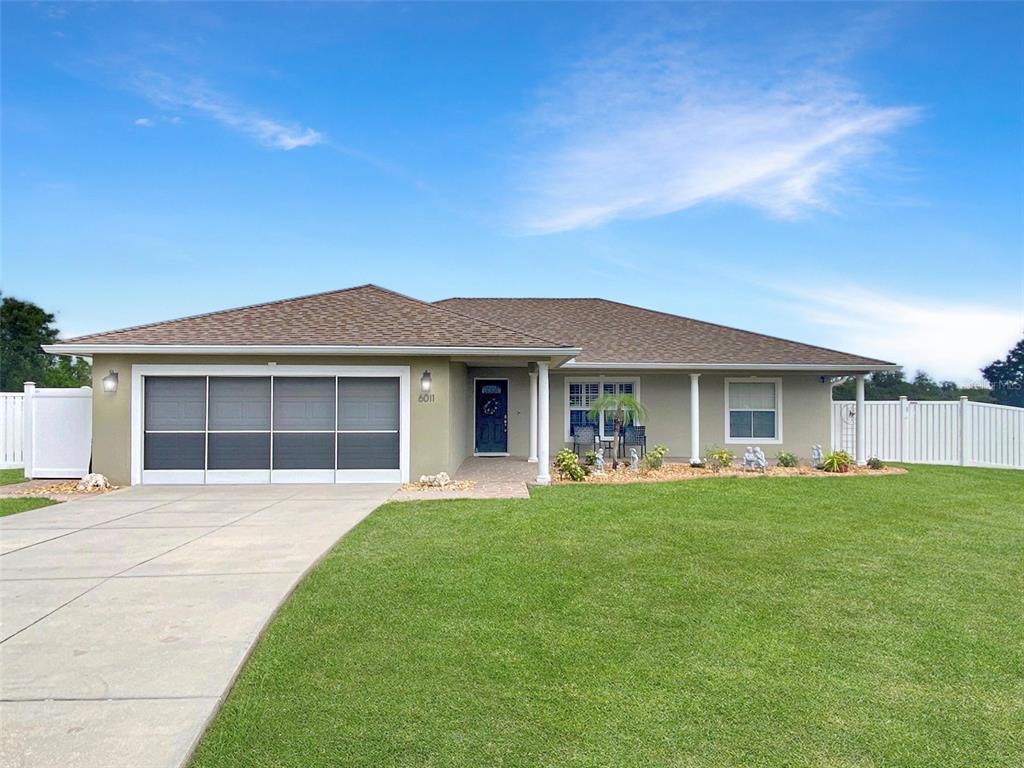 6011 Country Walk Lane Winter Haven, FL 33880 - Photo 1 of 1 a front view of a house with a garden and yard