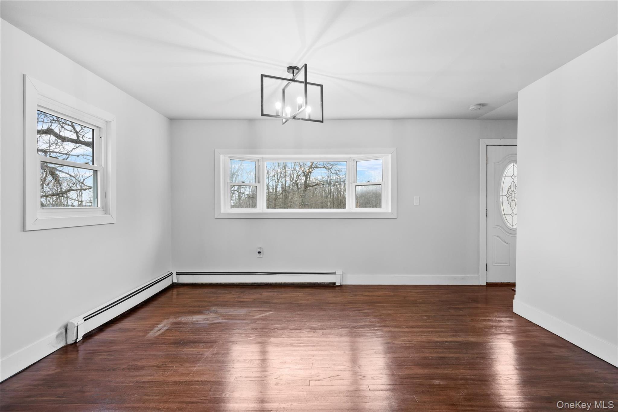 57 School Road Monroe, NY 10950 - Photo 16 of 33 an empty room with wooden floor and windows