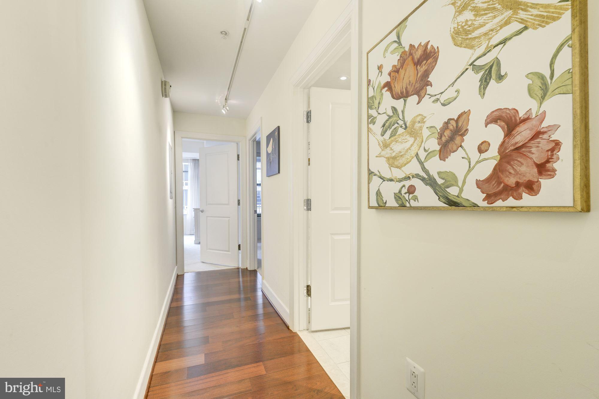 2425 L Street Northwest, Unit 539 Washington, DC 20037 - Photo 13 of 31 a view of a hallway with wooden floor and a bathroom