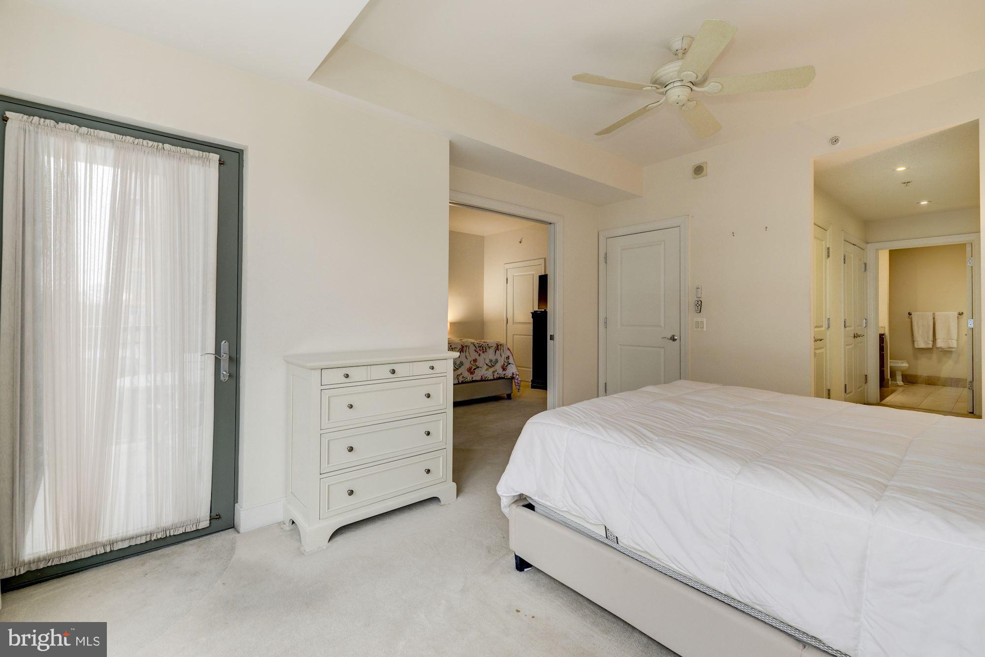 2425 L Street Northwest, Unit 539 Washington, DC 20037 - Photo 15 of 31 a spacious bedroom with a bed and a mirror