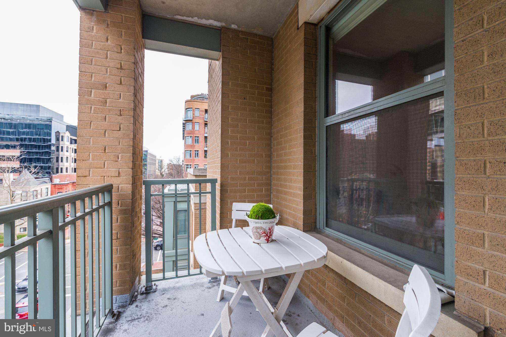 2425 L Street Northwest, Unit 539 Washington, DC 20037 - Photo 16 of 31 a view of a balcony with a table and chairs