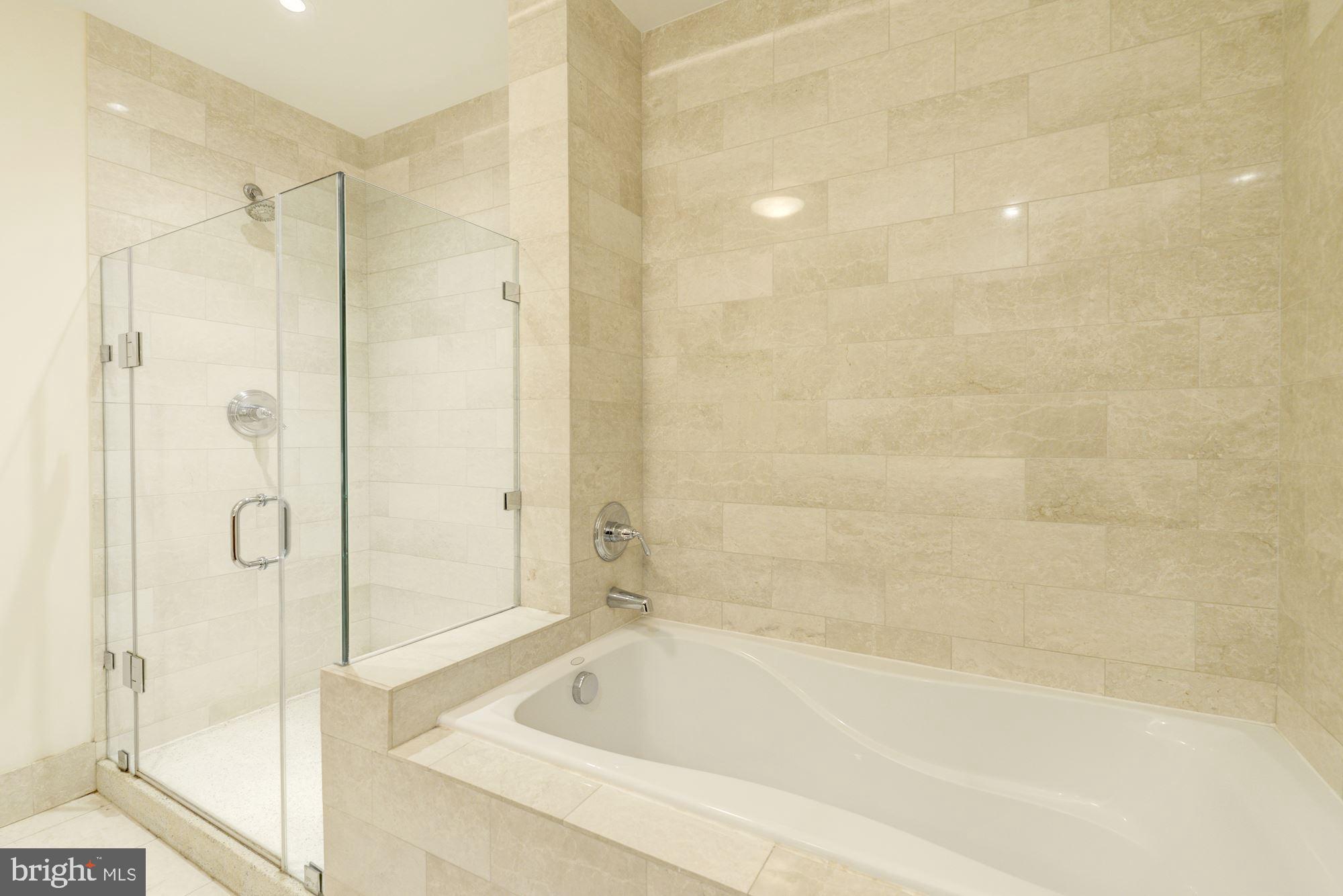 2425 L Street Northwest, Unit 539 Washington, DC 20037 - Photo 17 of 31 a bathroom with a bathtub and a shower