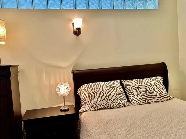 a bedroom with a bed and a night stand