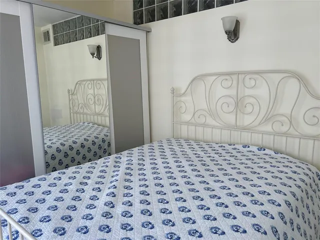 a bedroom with a bed and a shower