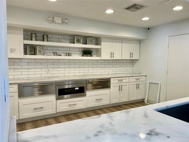 a view of a house with large windows and wooden floor