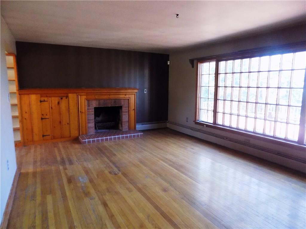 225 Beverly Way Butler, PA 16001 - Photo 5 of 18 Family room has huge window facing wooded private lot. Feature fireplace and hardwood floors.