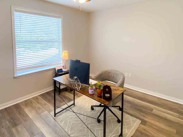 a work room with furniture and a window