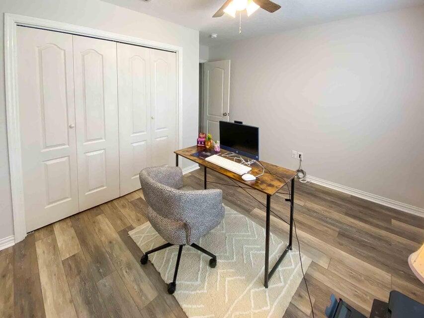 116 Dolphin Road Mary Esther, FL 32569 - Photo 12 of 13 a workspace with furniture and wooden floor