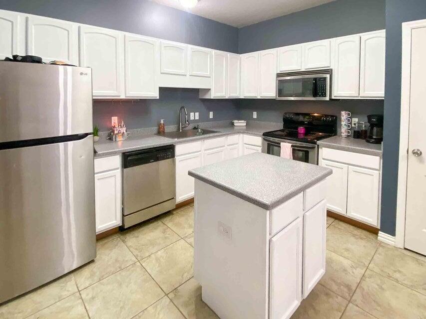 116 Dolphin Road Mary Esther, FL 32569 - Photo 3 of 13 a kitchen with stainless steel appliances granite countertop a refrigerator stove a sink and a microwave