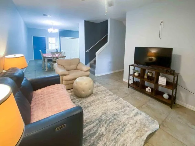 a living room with furniture and a flat screen tv