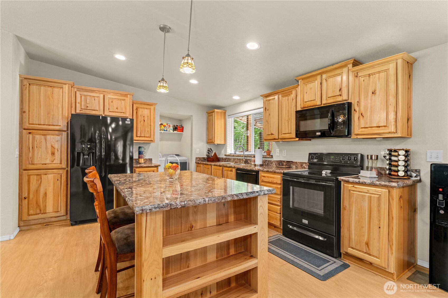 132 River Park Road Forks, WA 98331 - Photo 11 of 40 a kitchen with stainless steel appliances granite countertop a stove top oven a refrigerator a stove top oven and a sink with wooden floor