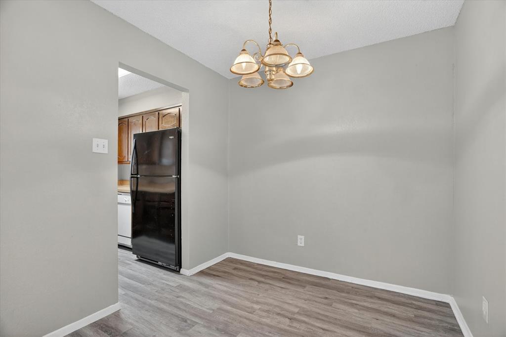 119 Del Rio Avenue, Unit C Benbrook, TX 76126 - Photo 5 of 17 wooden floor in an empty room with a window