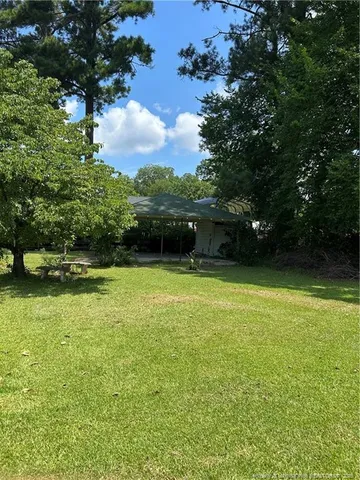 a view of a yard with a tree