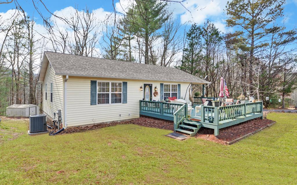 a view of a house with a yard and wooden fence