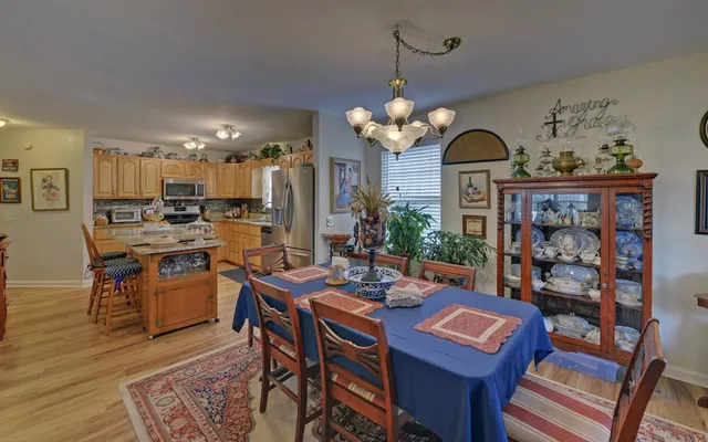 a view of a dining room with furniture and a chandelier