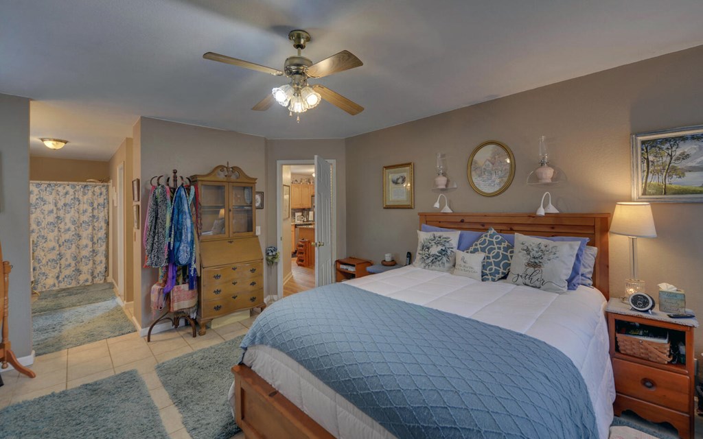 7300 Mr Bert Road Hiawassee, GA 30546 - Photo 17 of 48 a bedroom with a bed and a chandelier