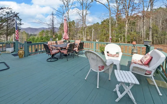 a view of a roof deck with table and chairs