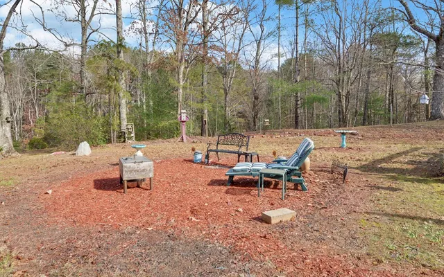 a view of a bench in the backyard of a house