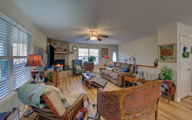 a living room with furniture a fireplace and a flat screen tv