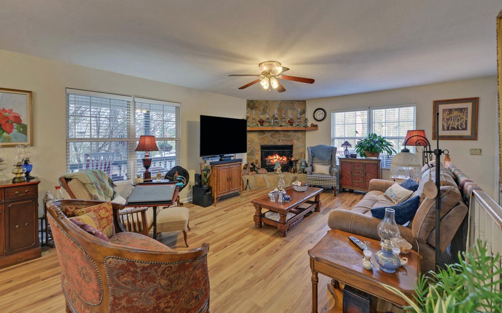 7300 Mr Bert Road Hiawassee, GA 30546 - Photo 10 of 48 a living room with furniture a fireplace and a flat screen tv