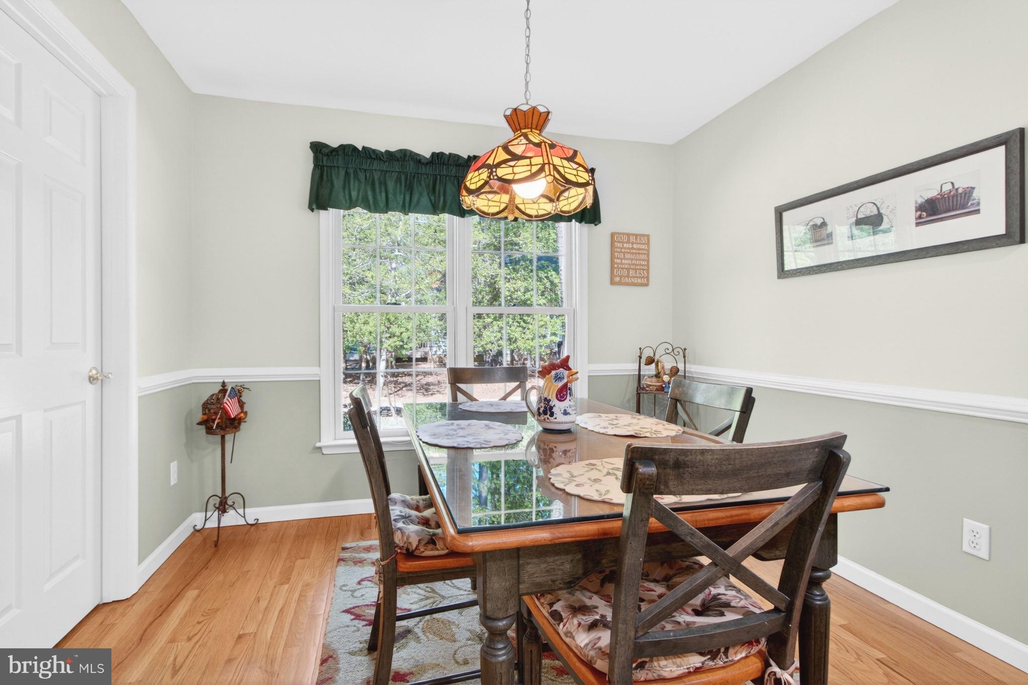 34371 Owls Nest Road Lewes, DE 19958 - Photo 17 of 58 a view of a dining room with furniture wooden floor and chandelier