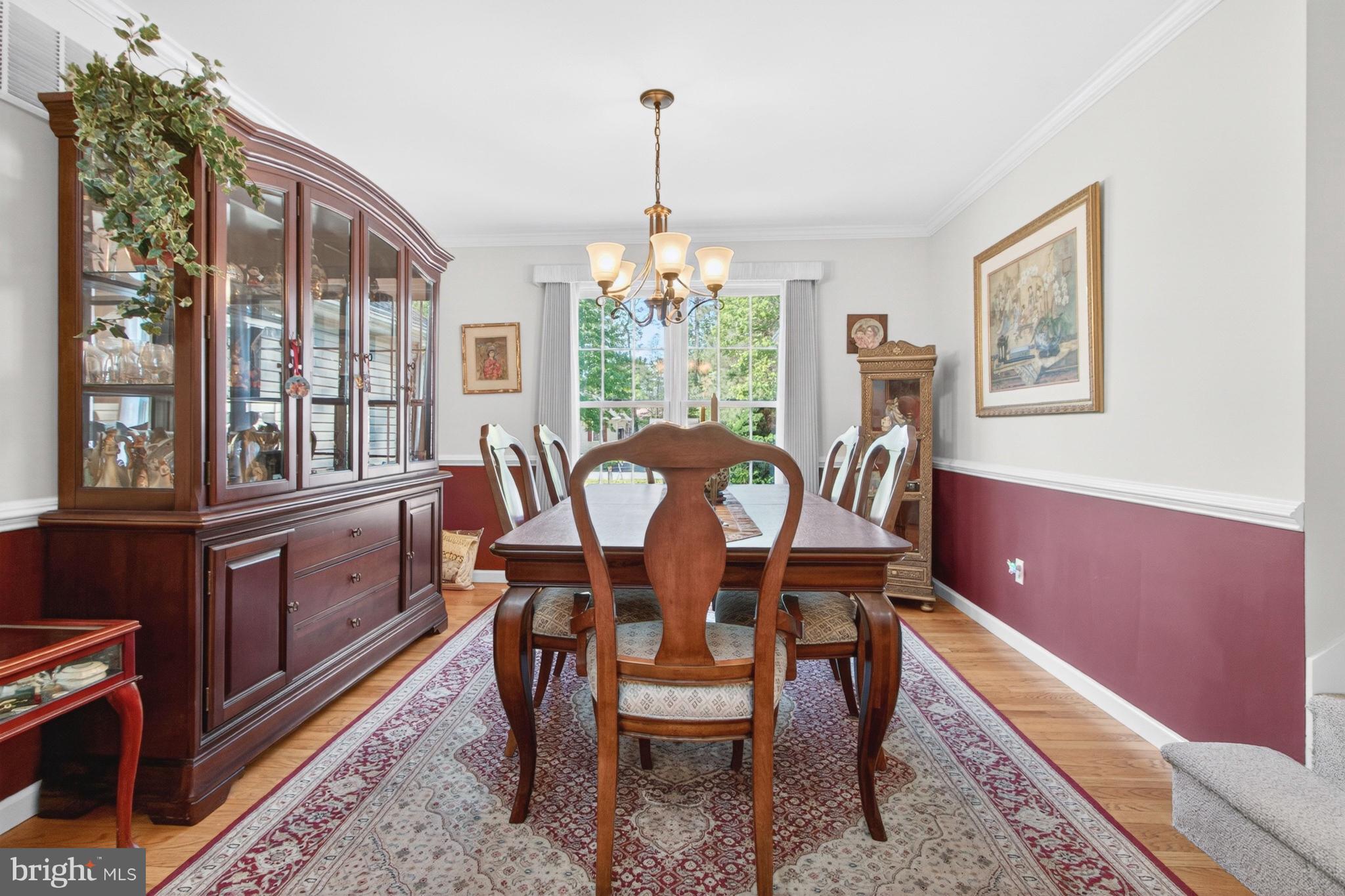 34371 Owls Nest Road Lewes, DE 19958 - Photo 18 of 58 a view of a dining room with furniture a chandelier and wooden floor