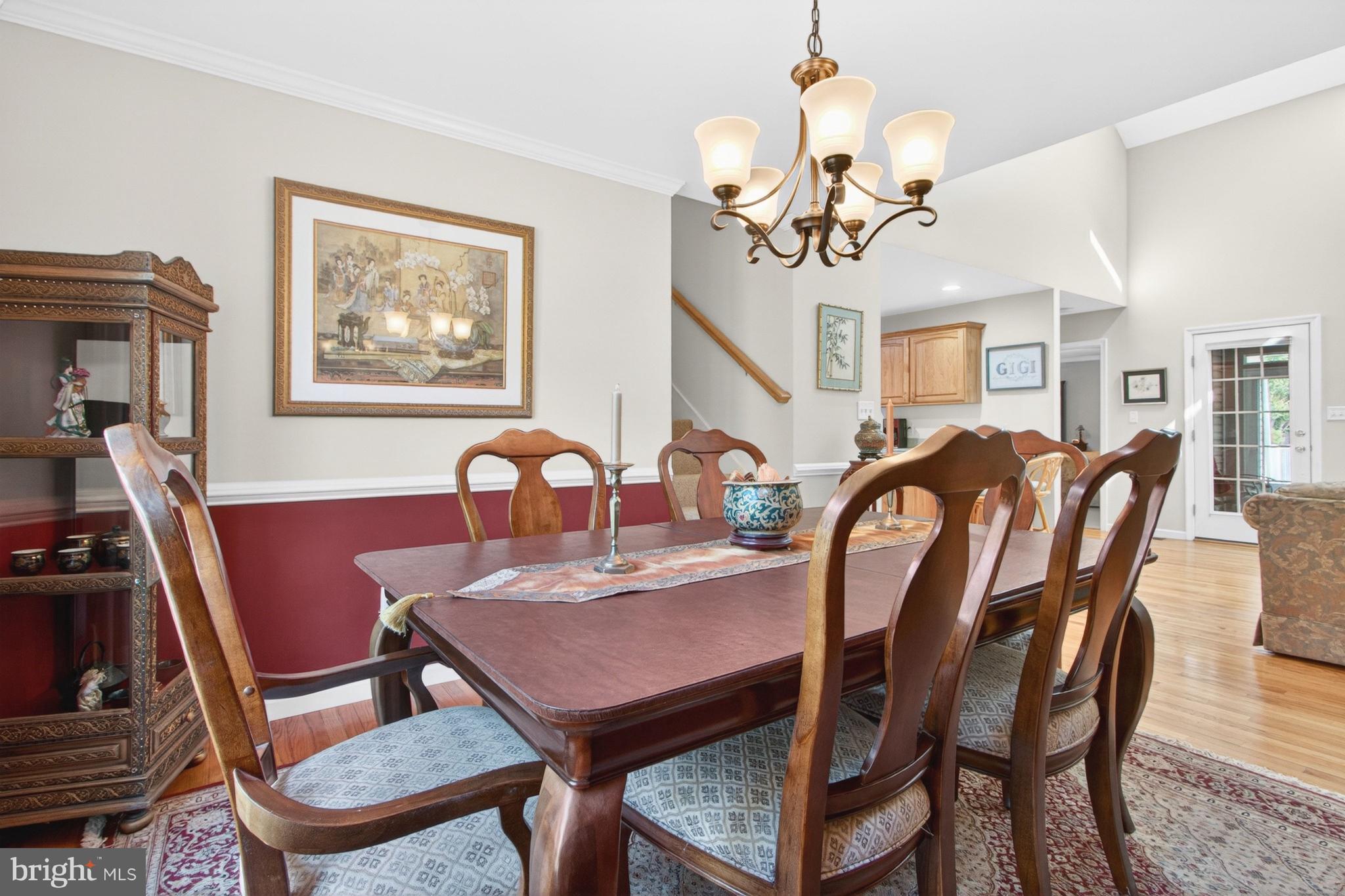 34371 Owls Nest Road Lewes, DE 19958 - Photo 19 of 58 a view of a dining room with furniture and chandelier