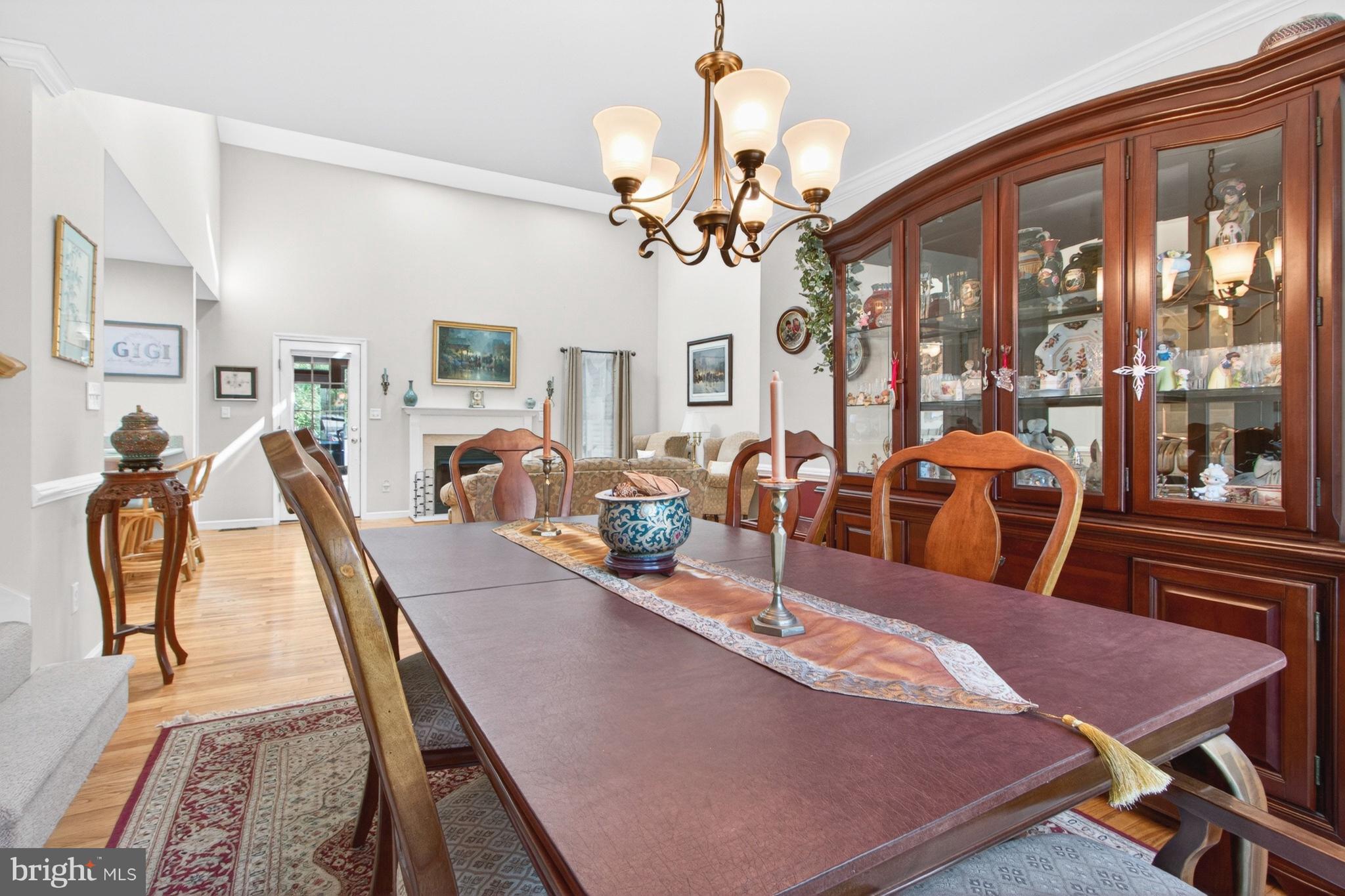 34371 Owls Nest Road Lewes, DE 19958 - Photo 20 of 58 a view of a dining room with furniture a chandelier and wooden floor