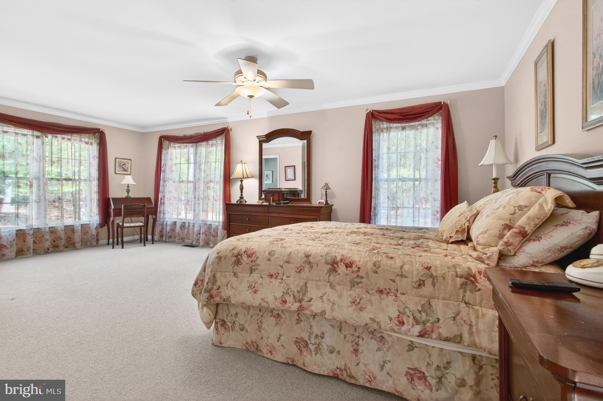 34371 Owls Nest Road Lewes, DE 19958 - Photo 22 of 58 a bedroom with a large bed and large windows