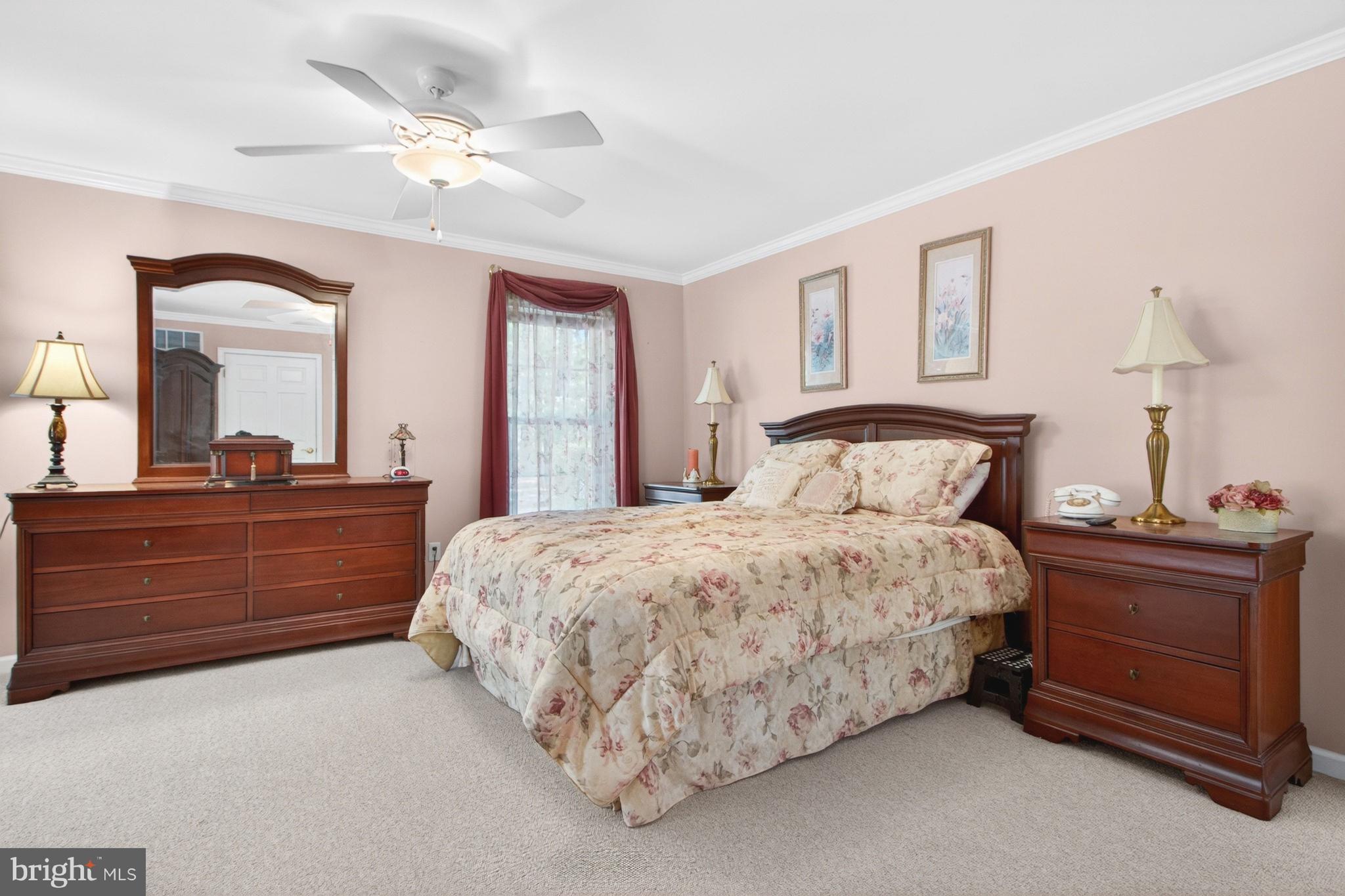 34371 Owls Nest Road Lewes, DE 19958 - Photo 26 of 58 a bedroom with a bed and a chandelier