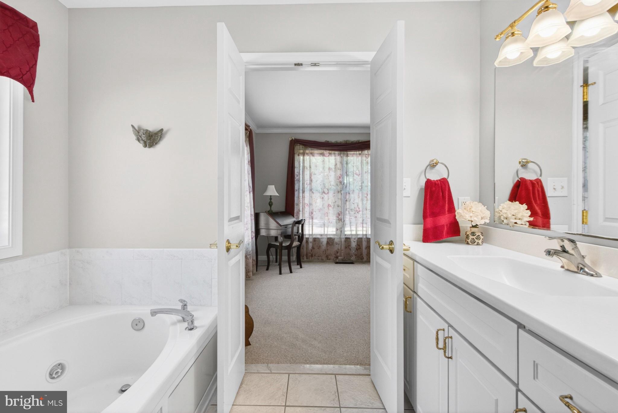 34371 Owls Nest Road Lewes, DE 19958 - Photo 29 of 58 a bathroom with a tub sink and mirror