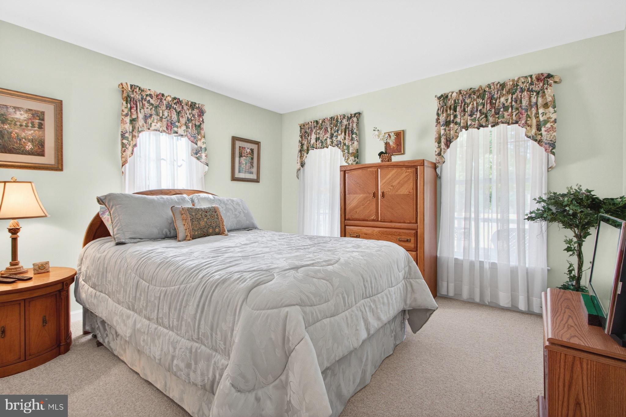 34371 Owls Nest Road Lewes, DE 19958 - Photo 30 of 58 a bedroom with a bed and a potted plant