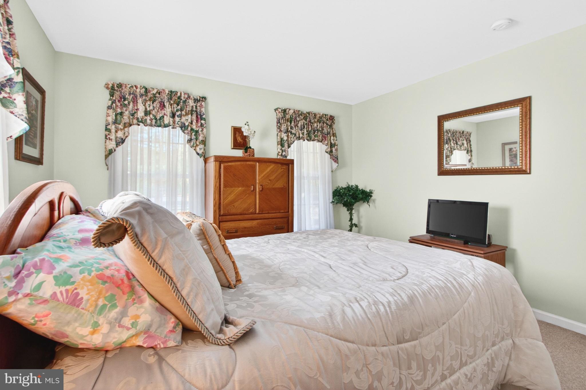 34371 Owls Nest Road Lewes, DE 19958 - Photo 31 of 58 a bedroom with a bed and a flat screen tv