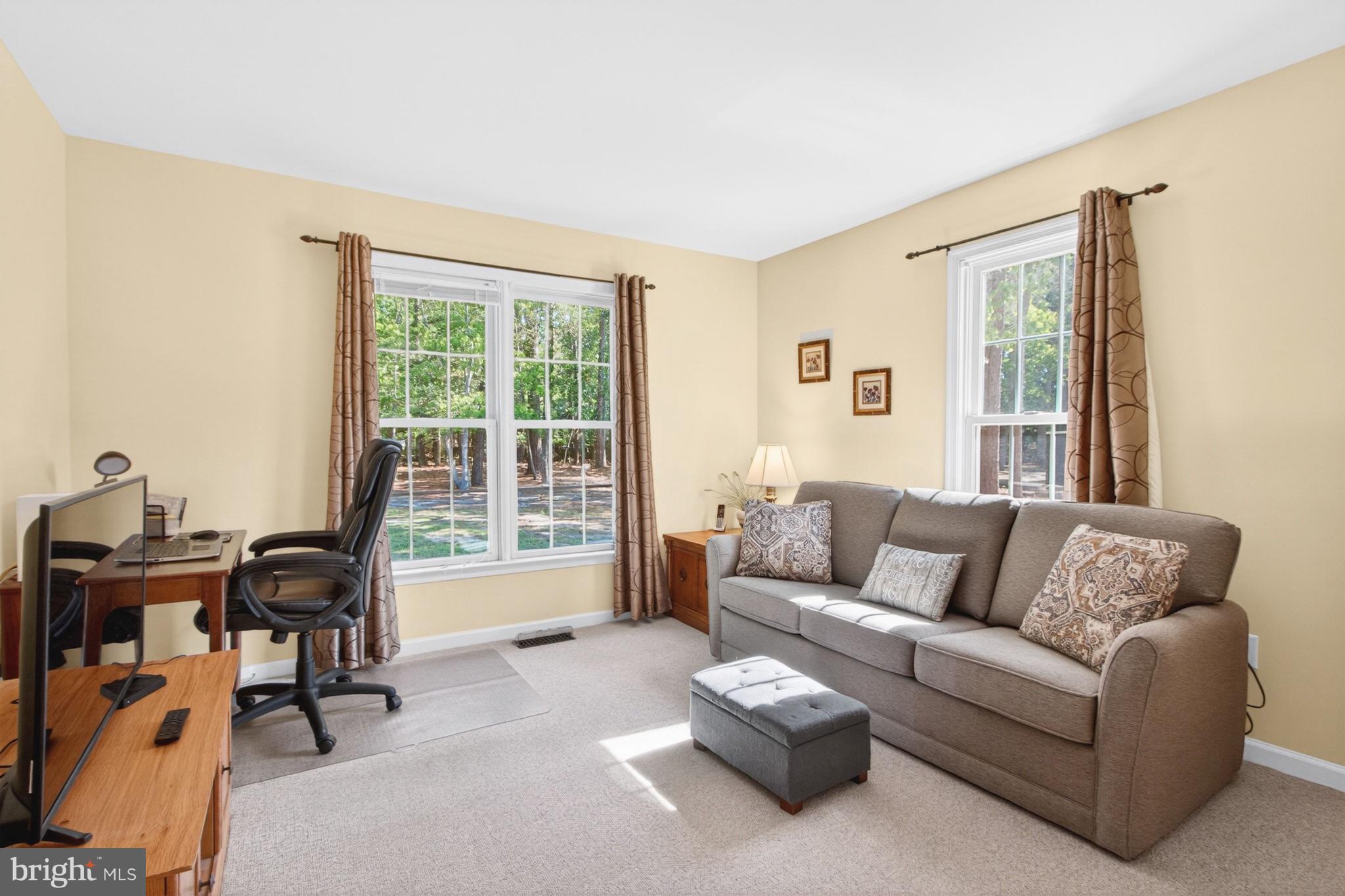 34371 Owls Nest Road Lewes, DE 19958 - Photo 34 of 58 a living room with furniture and floor to ceiling windows