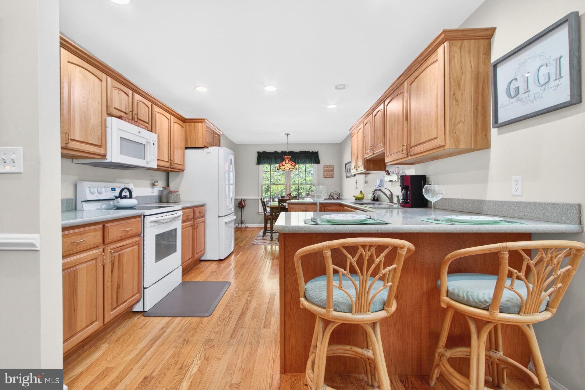 34371 Owls Nest Road Lewes, DE 19958 - Photo 10 of 58 a large kitchen with stainless steel appliances granite countertop a stove and a sink