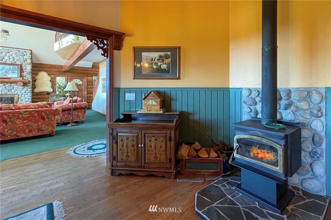 1006 Happy Valley Road Sequim, WA 98382 - Photo 18 of 40 a living room with furniture and a fireplace