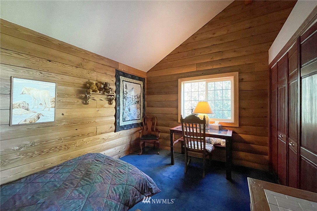 1006 Happy Valley Road Sequim, WA 98382 - Photo 27 of 40 a bedroom with furniture and wooden floor