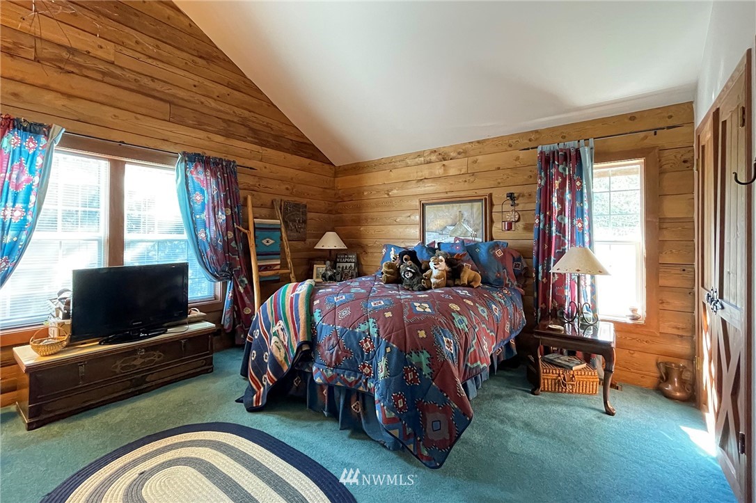 1006 Happy Valley Road Sequim, WA 98382 - Photo 29 of 40 a bed room with a bed and a television