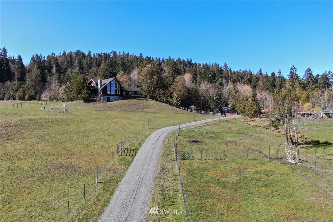 1006 Happy Valley Road Sequim, WA 98382 - Photo 4 of 40 a view of a yard with an trees
