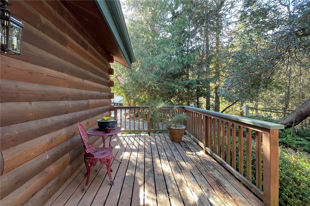 1006 Happy Valley Road Sequim, WA 98382 - Photo 8 of 40 a balcony with wooden floor and outdoor seating
