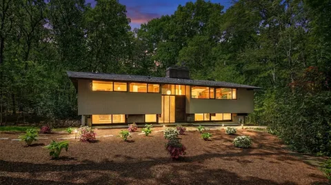 a view of a house with backyard porch and sitting area