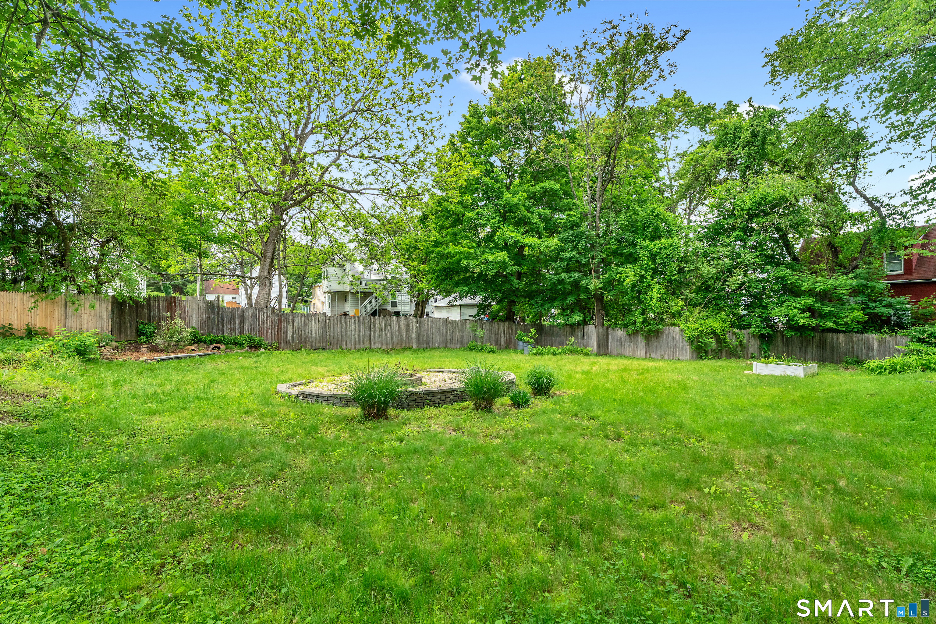 75 Summit Street Norwich, CT 06360 - Photo 38 of 40 a view of a garden with a tree