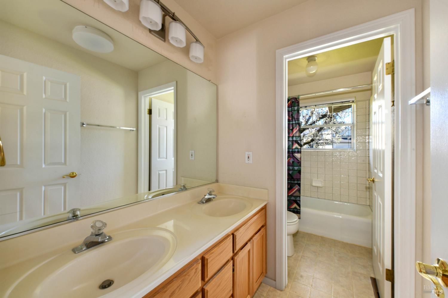 135 Fulton Place Windsor, CA 95492 - Photo 28 of 41 a bathroom with a sink a mirror and a shower